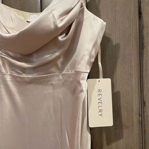 This is a beautiful bridesmaid dress by Revelry. The color is soft champagne.